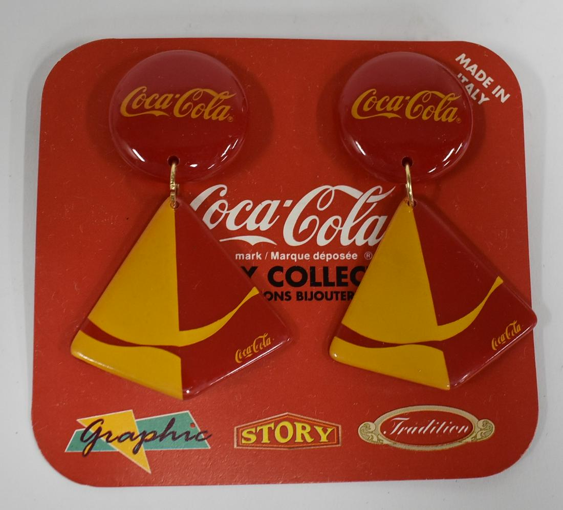 1970's Disco Coca-Cola Italian Sailboat Earrings: In original box. Coca-Cola medallions at the top and hanging red and orange sailboats marked Coca-Cola on the sails. Modele Dispose. Collection Bijouterie.