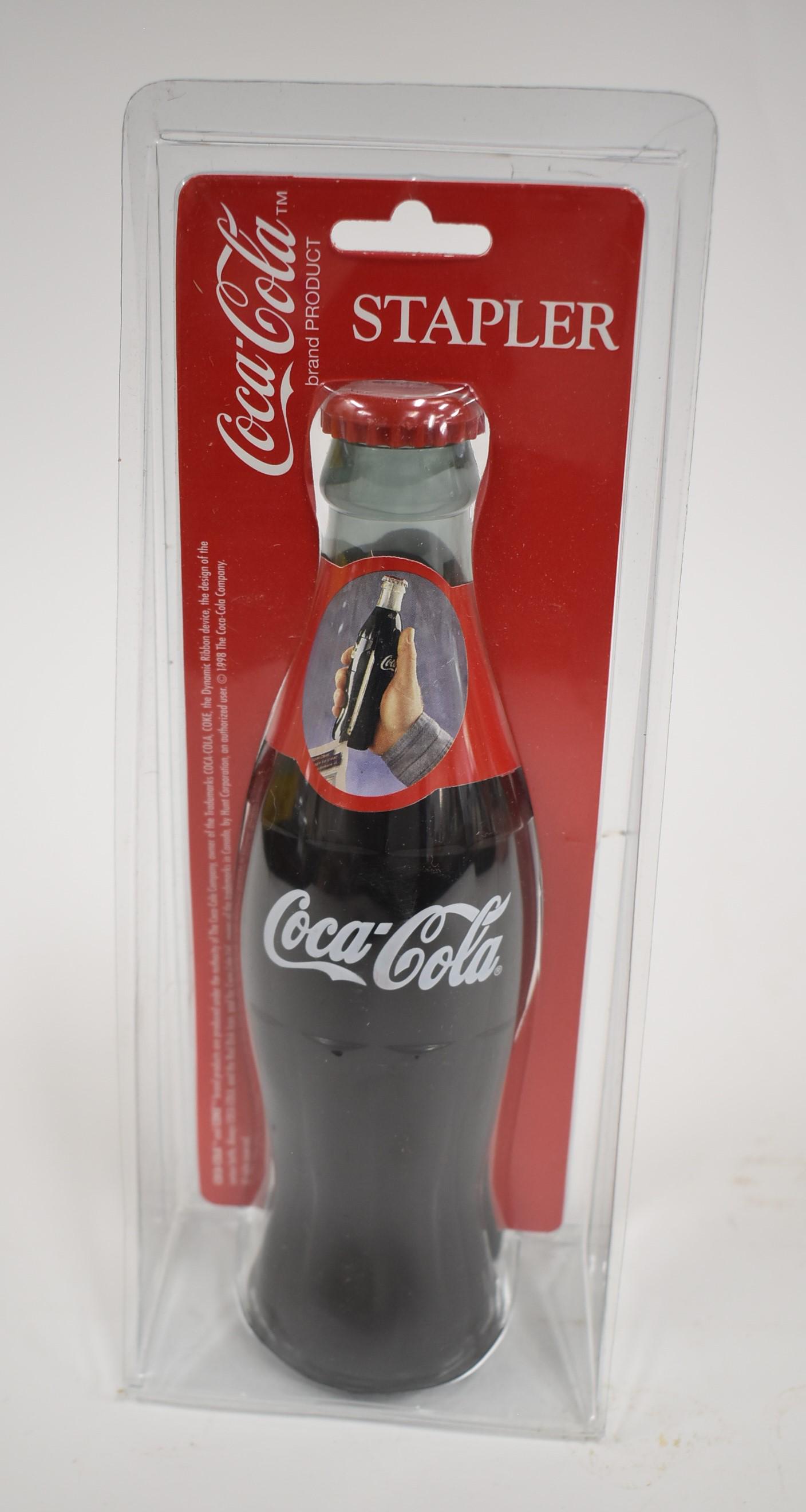 (1) Coca Cola Stapler: 1998 Coca Cola Stapler in Shape of a Coca Cola Bottle in Original Packaging Never Open.