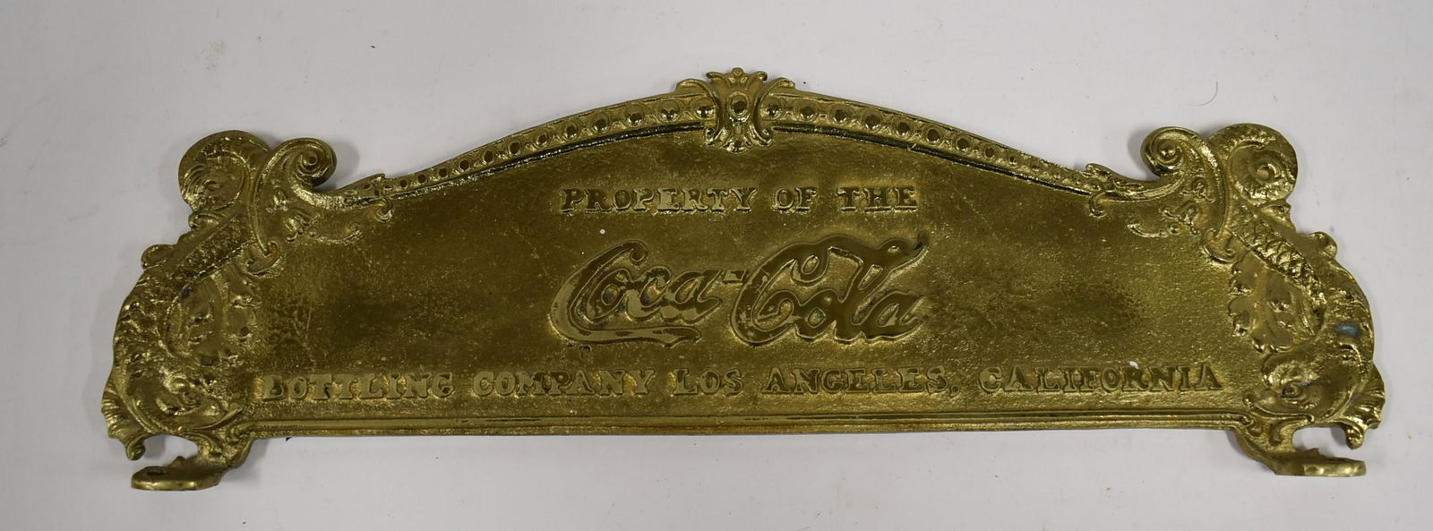 Coca Cola Ornate Brass Sign: Mountable.Coca Cola Bottling Company Los Angeles, CA. Reproduction sign for a cash register. 4.5 in H x 15 in W.