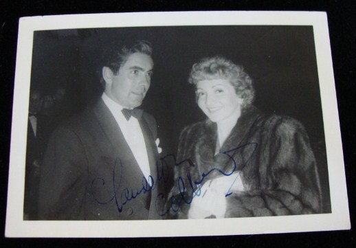 CLAUDETTE COLBERT SGD PHOTO & MEMORABILIA: With Tyrone Power "on the town" signed in blue ink Claudette Colbert. Claudette Colbert contact prints (46); affixed to two sheets - candid, scenes, from movies, full length glamour shots, c/u glamour