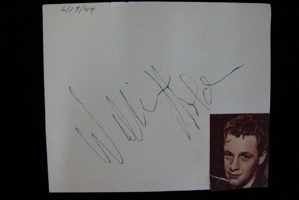 WILLIAM HOLDEN AUTOGRAPH: In black ink. Obtained on 6/19/44. On album page with a magazine photo of a young Holden.