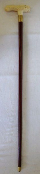CANE WITH CARVED IVORY HORSE HANDLE: Walking stick with three carved ivory horses heads forming the handle,Brass ferrule; 35 ½" L.
