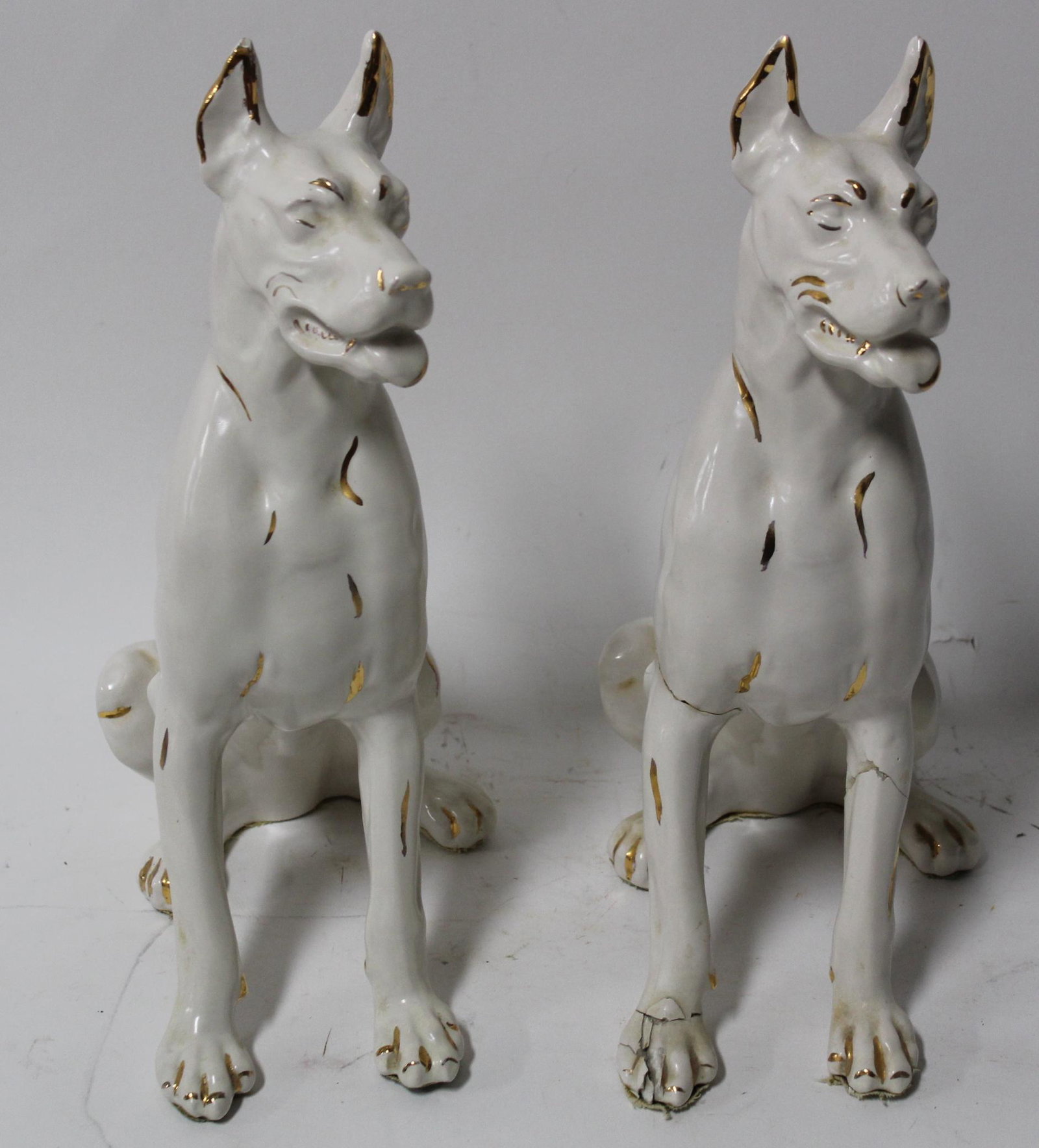 Doberman Porcelain Figures and a Second.: Includes a matching statue that has been repaired. 13.5 in.