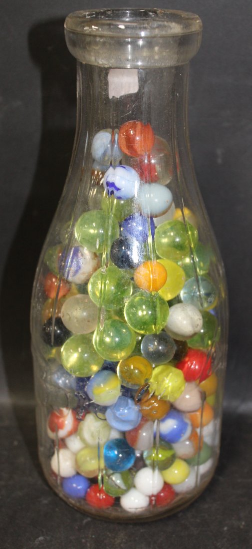 Lot of Marbles in Borden Glass Bottle.: Multi colored marbles in a vintage Borden's glass milk bottle.
