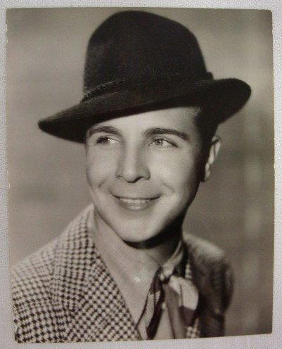 DICK POWELL PORTRAITS BY WELLBOURNE (5): All with back stamp for Scotty Wellbourne. Two with Photoplay library stamps. Two with Dell Pub. Co. stamps. Three with date stamps for 1934, 1935 and 1937. One with a p.s. for Flirtation Walk. Four a