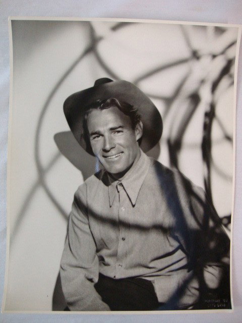 RANDOLPH SCOTT PORTRAIT BY OTTO DYAR: Double weight. Embossed mark- portrait by Otto Dyar at recto. Back stamp for Paramount & Otto Dyar. Photoplay Library stamp. Date stamp for 1932. Publicity snipe for Lone Cowboy. 10 3/4 x 13 3/4. VF-E