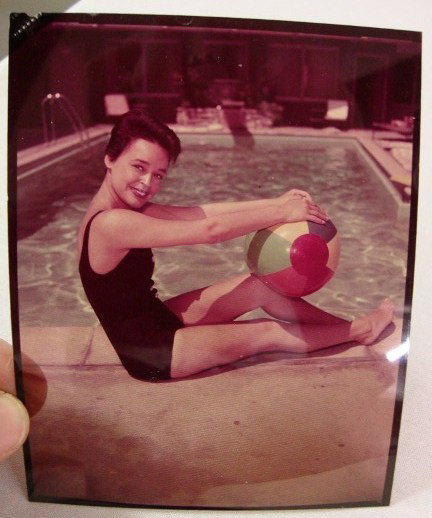 JILL COREY BATHING SUIT TRANSPARENCY: In a swim suit, with beach ball, at pool's edge. Color transparency 4" x 5"