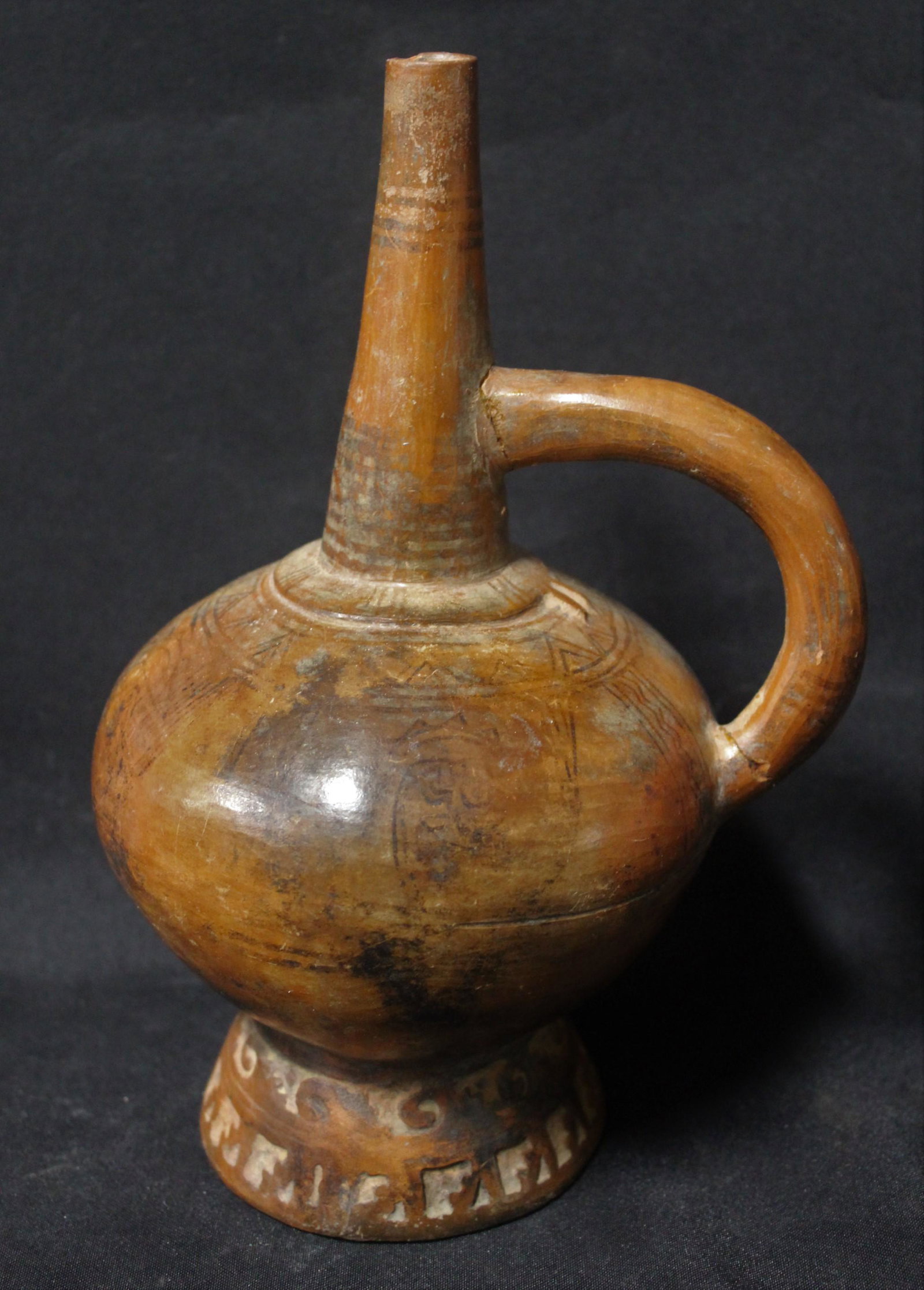 Ancient Paracas Peruvian Clay Vessel: Handled with narrow neck. Incised decoration. 9 in H x 6 in W.