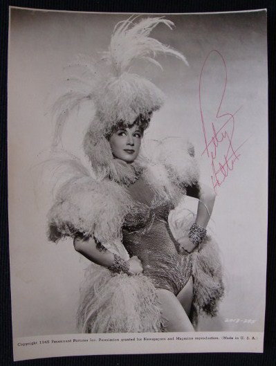 BETTY HUTTON SIGNED PHOTOGRAPH: 1945 Paramount picture publicity photograph of Betty Hutton. Signed in red ink Betty Hutton. 7 1/4 x 9 3/4. VF-F