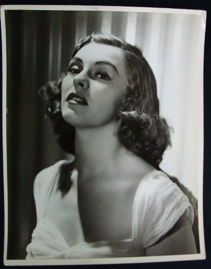 NANCY KELLY PORTRAIT BY HURRELL: Publicity photo for Splinter Fleet. Back stamp for George Hurrell. Marked Exclusive. Dell Pub. Co. stamp & date stamp for 1938. Double weight. 11 x 14. VF-F (margin crease U.R. probably visible in pho