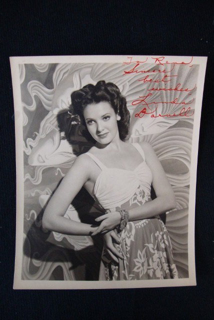 LINDA DARNELL SIGNED PHOTOGRAPH: Signed in red ink, To Rena, Sincere best wishes, Linda Darnell. Double weight. The lot is accompanied by nineteen other Linda Darnell photographs (probably all reprints.) 8 x 10 VF