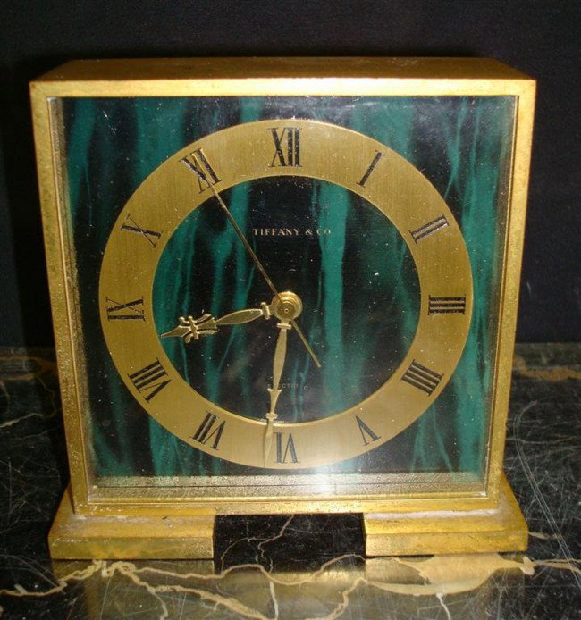 TIFFANY & CO. BRONZE CLOCK: bronze and glass clock made by Concord Watch Co., marked on the dial "Tiffany & Co." and at the back "Concord Watch Co. Swiss"; 4-3/4in. H.