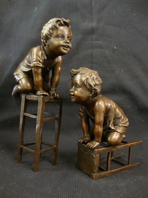 JUAN CLARA; PAIR OF BRONZE GROUPINGS SIGNED: bronze, young boys on stools signed; 6-1/4in. - 8-1/4in. H.