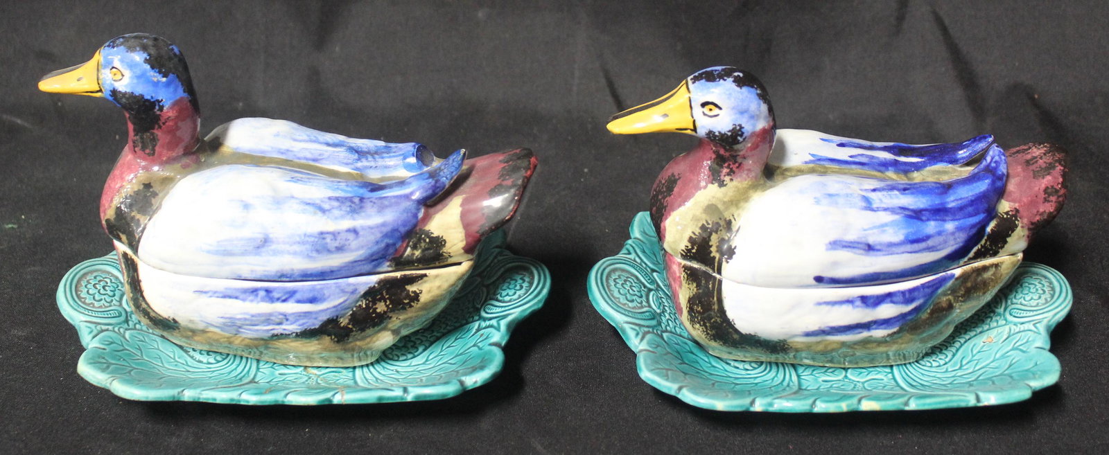 Pr. Unusual Pottery Duck Boxes w/Undertrays: Hand painted duck boxes with teal chased pottery bases. one underplate chipped and has been repaired. Overall size 5"Tall