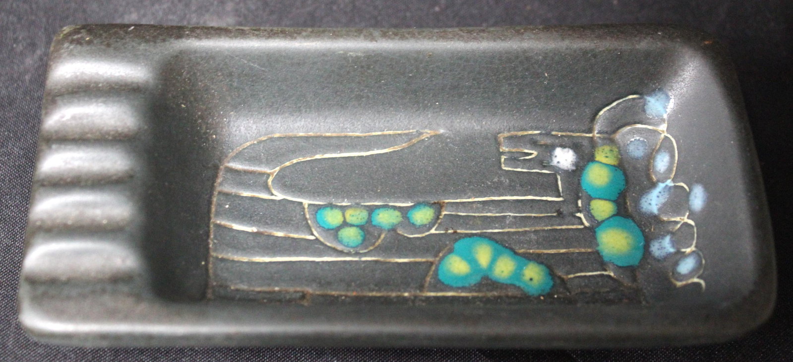 Mid Century Modern Ashtray Sgd.: Signed indicernably at the underside. 5.5 in L x 2.75 in W.