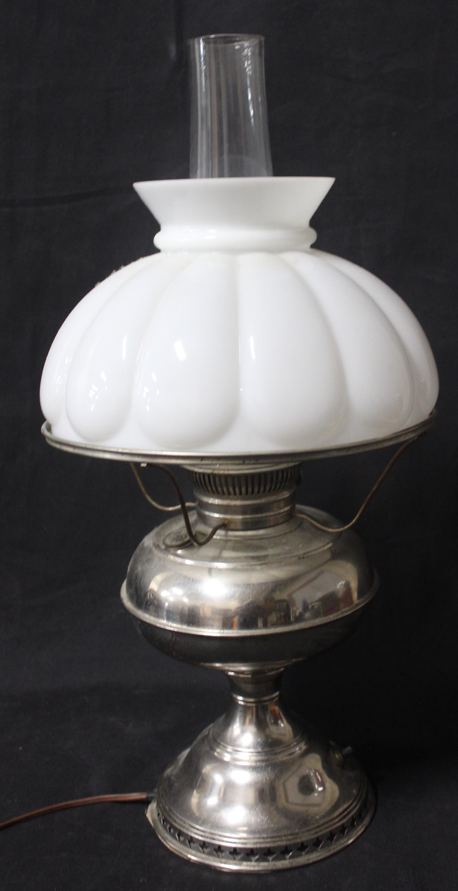 Vintage Gone With The Wind Lamp: Electrified. Oil Lamp. Polished Nickle Metal , electified . Milk glass shade with hurricane globe. Overall Size 22"H x 10"W