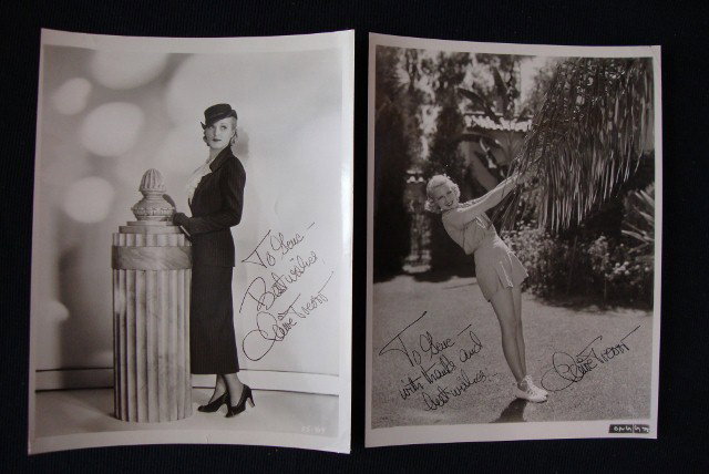CLAIRE TREVOR ISP'S: Both inscribed to Gene Andrewski. Both with backstamp for King Feature Syndicate, Inc. Both are fashion photos with publicity snipes for the outfits being worn & for the 20TH Century - Fox film "Song 