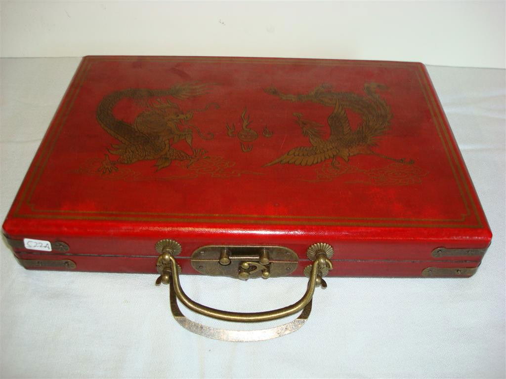 CHINESE MAH JONGG SET: painted leather wrapped fitted case with dragon and phoenix design; complete with mah-jongg pieces and game directions; 11.5in. W.