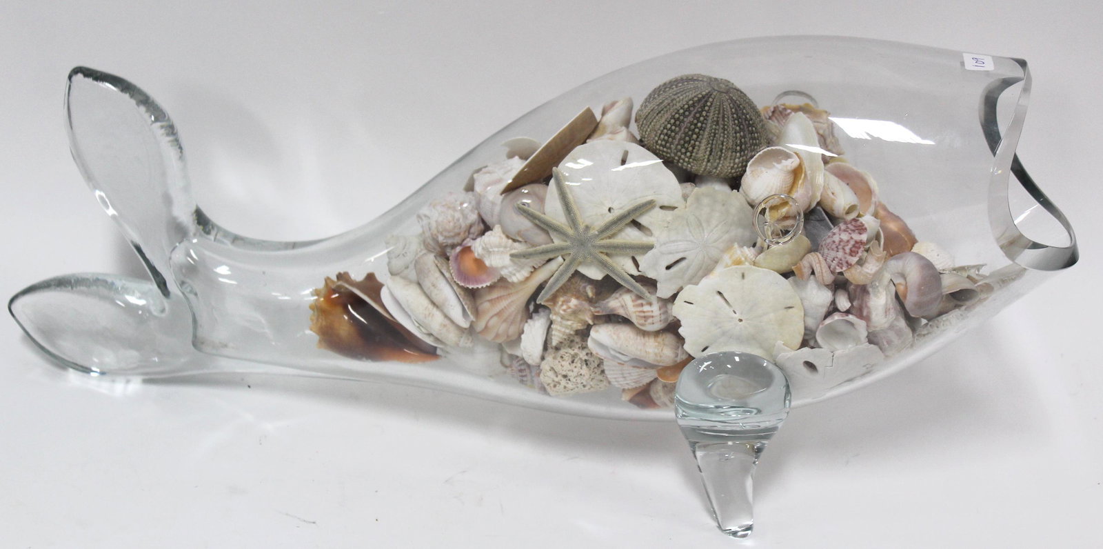 Antique Glass Dolphin Figure: Dolphin figure made of glass. Filled with seashells and similar beach finds. 20.5"L x 9.5"H