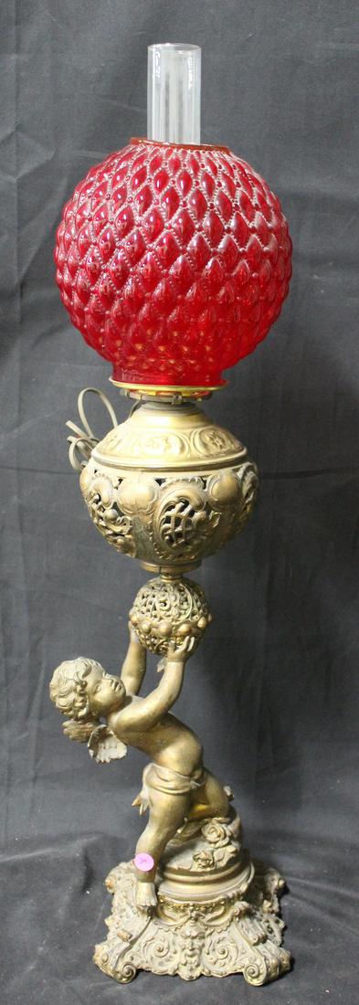 Gone With the Wind Lamp: Red spherical shade held aloft by a full bodied cherub. 35".