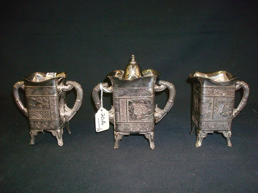 THREE PIECE VICTORIAN SILVER PLATED COFFEE SET: Coffee box, sugar, and creamer set. Date on base Nov. 30th, 1890. Rockford Silver Plate. 6-1/2 high with lid; 5 high. Intricate designs.