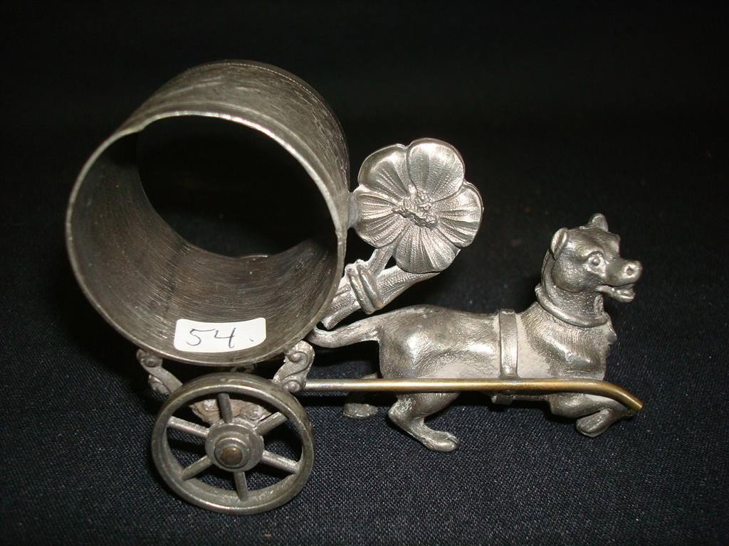 AMERICAN VICTORIAN SILVERPLATE NAPKIN RING: Dog pulls napkin ring on wheels.