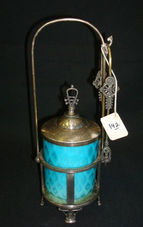 VICTORIAN PICKLE CASTOR WITH BLUE SATIN GLASS INSE: American Victorian silver plate pickle castor with a blue quilted satin glass insert. Mark for Rogers. 11 1/2" H.