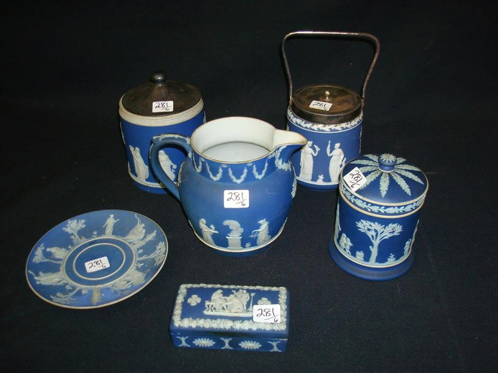 LOT OF WEDGWOOD PIECES: The lot includes a covered biscuit barrel; a covered humidor; a pitcher; a covered box; a large pitcher; and a plate.