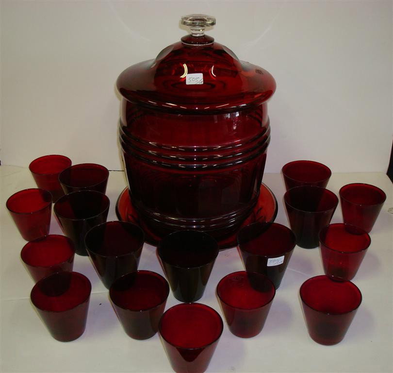 ANTIQUE RUBY GLASS COOLER AND CUPS (19 PCS): Monumental ruby glass barrel shaped covered jar. Has underplate or drip plate. . Beveled thumbprint pattern to barrel shaped jar. 17 cups. 14 1/2" H. 10" W. 10" W. underplate and 3" to 3 1/2" cups