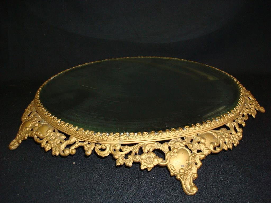 FANCY MIRRORED AND BRASS FOOTED TRUMEAU: Beveled mirror. Fancy footed gilt metal base. 17" D