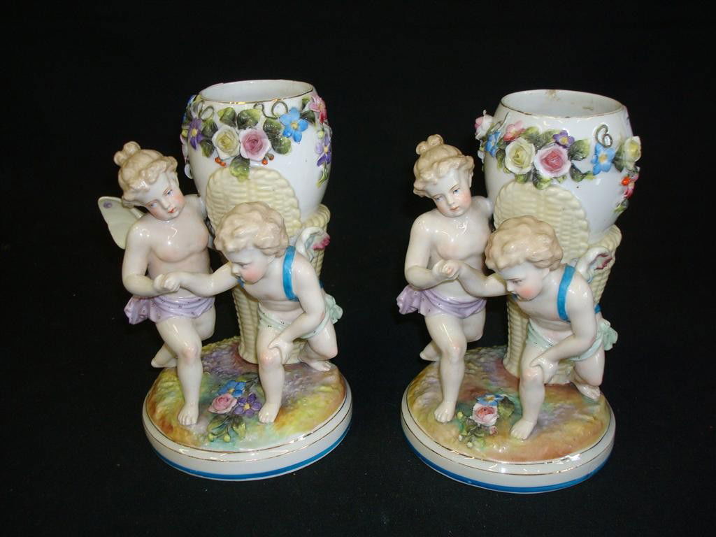 PAIR OF MEISSEN CHERUB VASES: Blue crossed marks. (Small rim chip.) 9" H