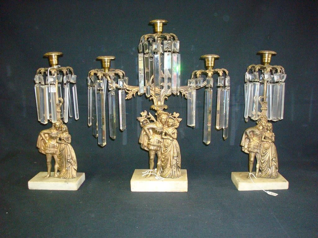 VICTORIAN GIRANDOLE SET: Bronze with cut glass prisms. Figural supports. Marble bases. 18" central three armed candleabra and 14" single side piece candleabra.