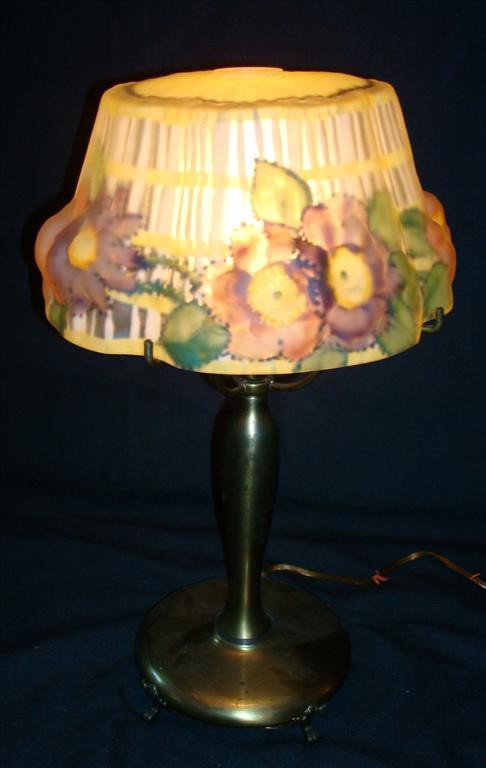 PAIRPOINT PUFFY LINEN FOLD BOUDOIR LAMP: Floral border. Open top.Signed on the shade and the base. Shade sits on the four pronged base. 8 1/2" D. 15" H.