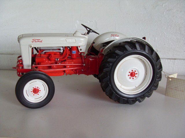 1953 FORD TRACTOR: Red & white Golden Jubilee Model Ford tractor. With original tag. 1:12 scale. 10-1/2" long