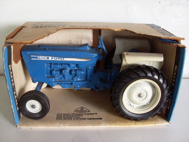 FORD 4600 TRACTOR IN ORIGINAL BOX: Blue & white Ford 4600 tractor in original box. Manfactured by Ertl. Stock #805. 10-1/4" long