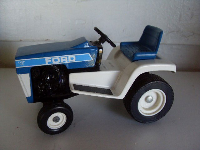 TWO FORD LGT-12 FORD TRACTORS: Two blue & white Ford LGT-12 tractors. Marked Special Edition, March 1984. #'d at bottom 1454. Also numbered 808-8403. (second tractor not pictured) 6" long.