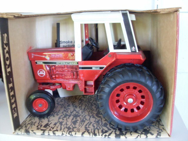 INTERNATIONAL 1586 TRACTOR WITH CAB: Red and white International 1586 tractor with cab. (Graphics on engine are for the 1486 model. Also has a Red Power logo on the engine.) 1/16 scale. Die-cast metal. With smoke stack, rear hitch, and s