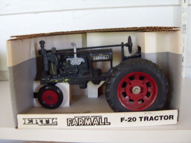 MCCORMICK-DEERING FARMALL F-20 TRACTOR: Black McCormick-Deering Farmall F-20 tractor with red rims. Vintage Series. 1/16 scale. Steerable front end, rear hitch, rubber tires. Stock #260. Marked 2802. 7-1/2" long