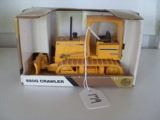 JOHN DEERE 550G CRAWLER: Yellow John Deere 550G crawler. 1/32 scale. In original packaging. Die-cast metal. Movable tracks. Rear hitch. Manufactured by Ertl. 5" long