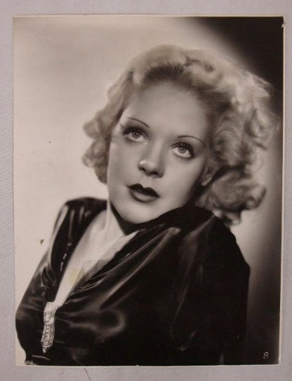 ALICE FAYE PORTRAIT BY ANTHONY UGRIN: A close up glamour portrait by Anthony Ugrin. Date stamp for Feb. 12, 1934 and July 6, 1934. Typed publicity snipe for Scandals. Backstamp for Fox Film and the photographer. A red china marker sketch 