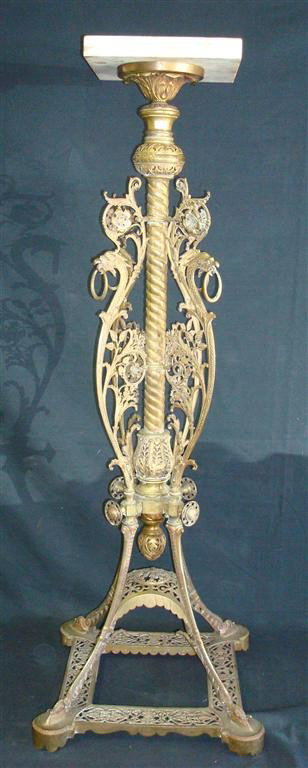 ORNATE BRASS PEDESTAL WITH GRIFFIN HEADS: Filigreed designs with a marble top 46"H. 10" square