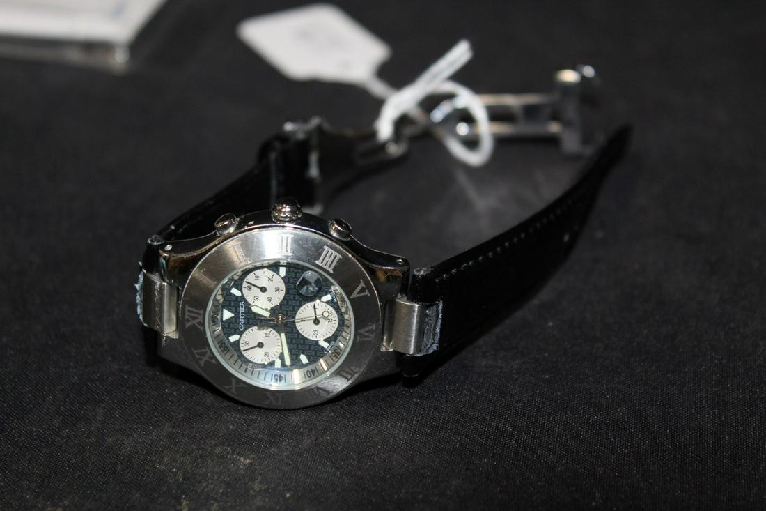 Cartier Chronograph: Marked Cartier on the dial. Roman Numberals on the outer encasement. Marked at the back Cartier Chronograph. 2424 Water resistant. 100m/330ft. Stainless Steel. Numbered 46330PL. Leather band