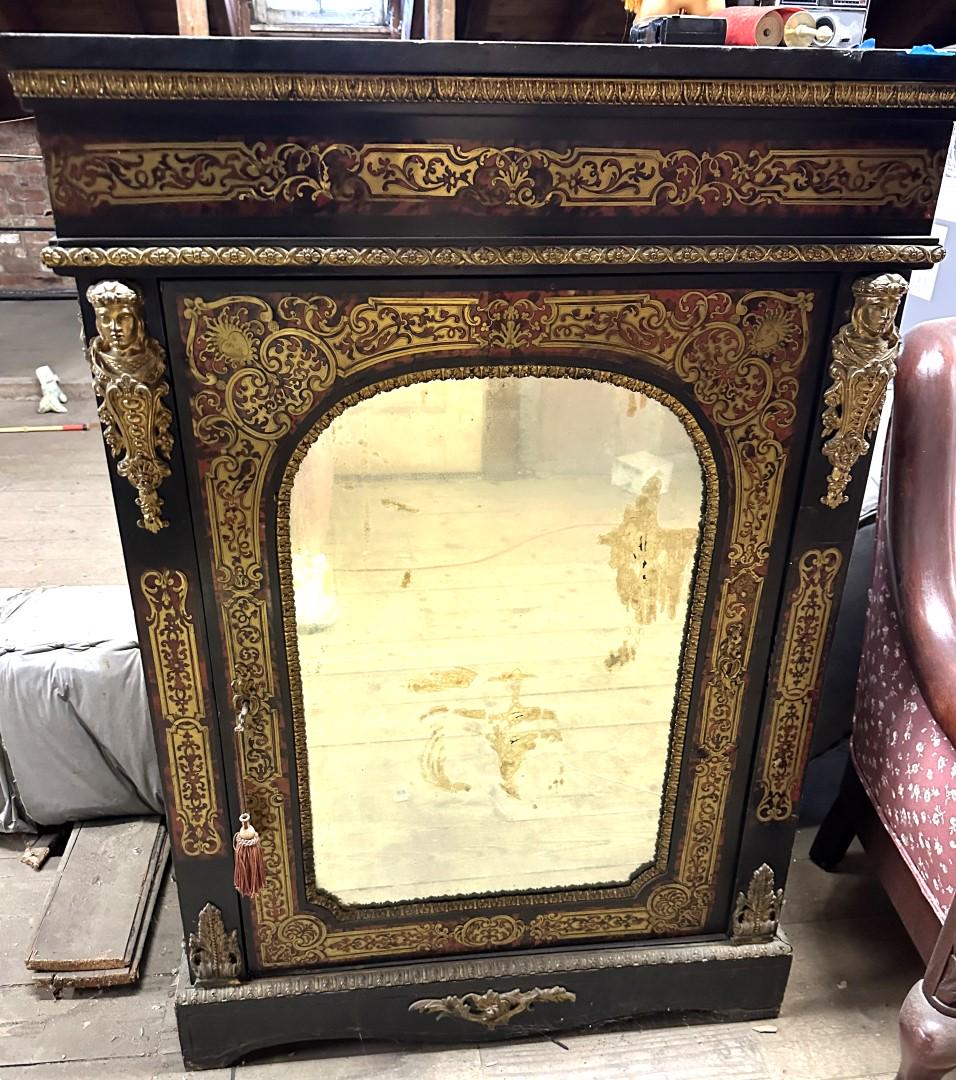 19thC. Napoleon III French Boulle and Ebonized Wood Cabinet: Intricately inlaid brass and tortoise shell decorated side ebonized wood side cabinet. One-door with arched mirror. Bronze ormalu mounts and original hardware; 46in.H. x 32in.W. x 12in.D.
