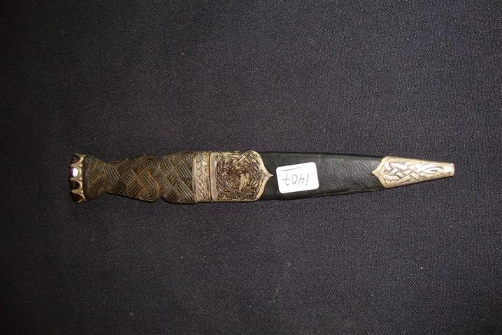 SCOTTISH KNIFE IN STERLING MTD CASE WITH TOPAZ: Scottish knife is encased in a sterling silver mounted leather and carved Bakelite case with a faceted topaz mount at the end. Marked Made in Scotland with three hallmarks 8" L