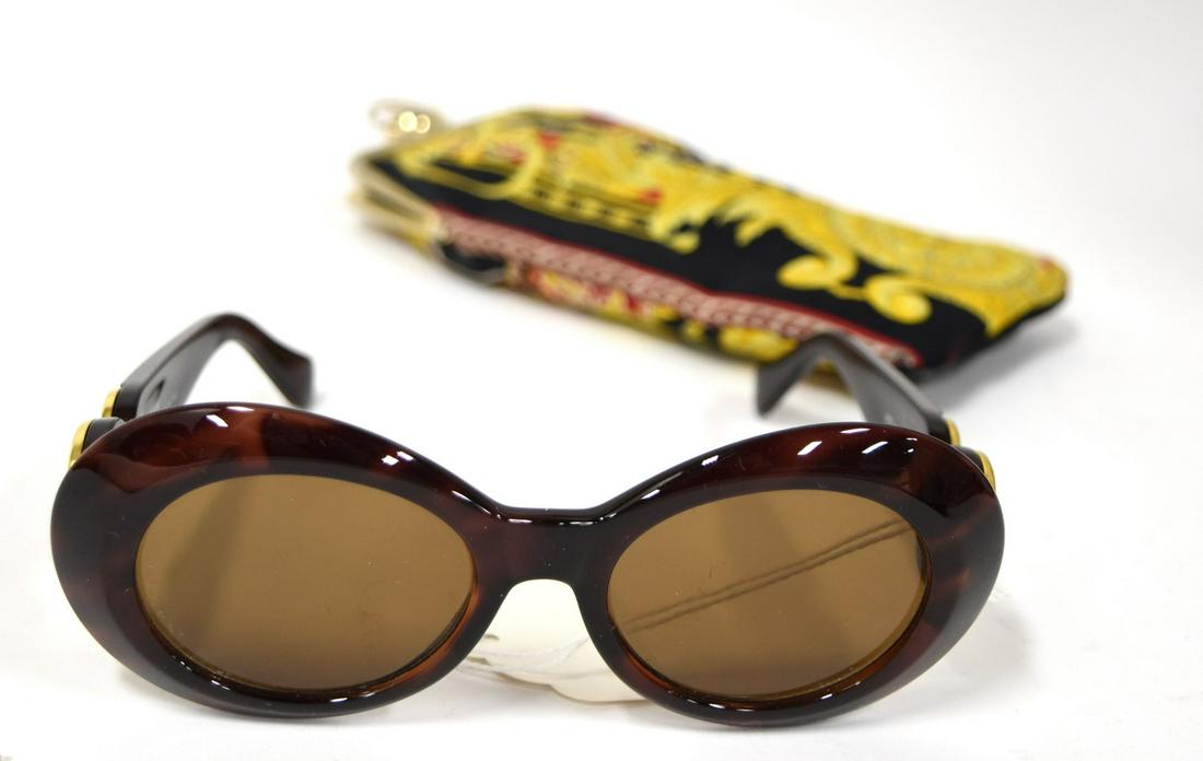 Gianni Versace Sunglasses in Versace Case: Tag inside case is marked Realizzato Versace. Glasses are marked Gianni Versace and have elaborate gold logo designs at both side rims