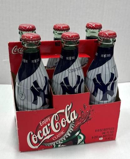 100th Anniversary Coca-Cola Yankees Six Pack: 1903-2003 100th Anniversary of The New York Yankees Six Pack. Unopened. In carrier. "Pinstripe" clad bottles with 1903-2003 dates at top of each bottle.