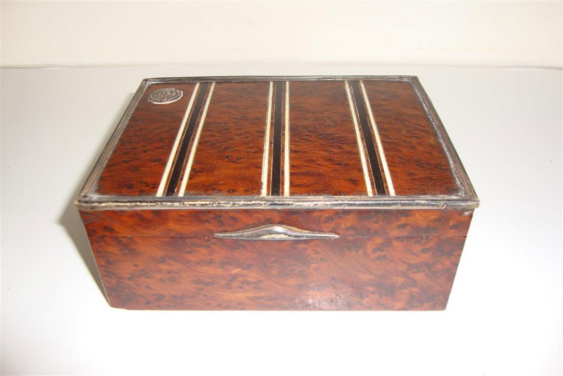 FRENCH BURLED WALNUT IVORY AND METAL BOUND BOX: Cigarette box. Wood lined. Marked Maquet Paris and Nice 5 1/2"W. x 4"L. x 2"H. (Small veneer loss and some crazing)