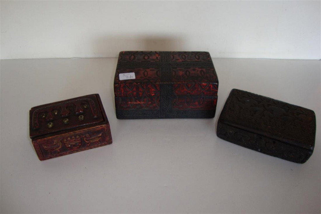 THREE CARVED WOODEN TIBETAN BOXES: One with a sliding lid. Varying sizes 4"W. to 6"W. 2 1/2'l. to 3 1/2"L and 1"H. to 2 12"H.