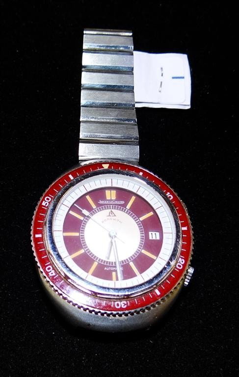 JAEGER LE COULTRE MAN'S WRISTWATCH: Signed Memovox model with alarm and date, stainless steel water resistant case with rotating bezel, red insert and dial, LeCoultre stainless bracelet, automatic, 40mm