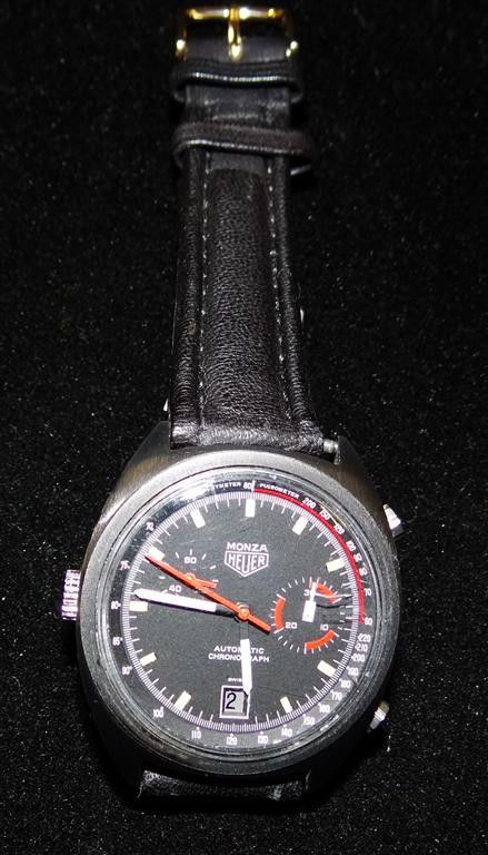 MONZA HEUER MAN'S WRISTWATCH: Automatic date chronograph with minute register and constant seconds, slate dial with both pulsometer and tachymeter scales, orange sweep, seconds and accents, titanium or steel case, leather band, 37